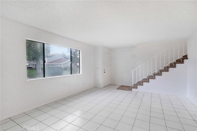 2061 W Redlands Blvd Unit 8C, Redlands, CA 92373 - tiled spare room featuring stairs