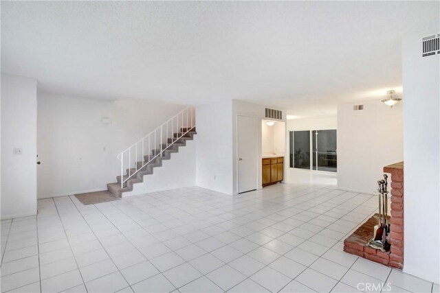 2061 W Redlands Blvd Unit 8C, Redlands, CA 92373 - unfurnished living room featuring stairs and light tile patterned floors