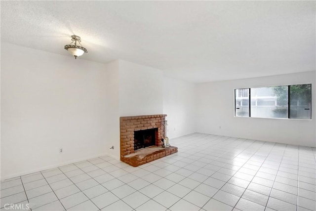 2061 W Redlands Blvd Unit 8C, Redlands, CA 92373 - unfurnished living room featuring light tile patterned floors, a fireplace, and a textured ceiling