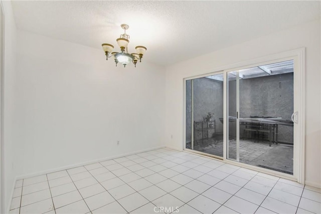 2061 W Redlands Blvd Unit 8C, Redlands, CA 92373 - spare room featuring a chandelier and a textured ceiling