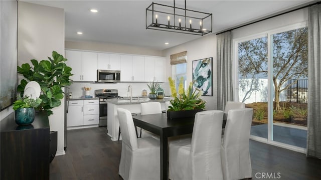 dining room with dark hardwood / wood-style flooring and sink