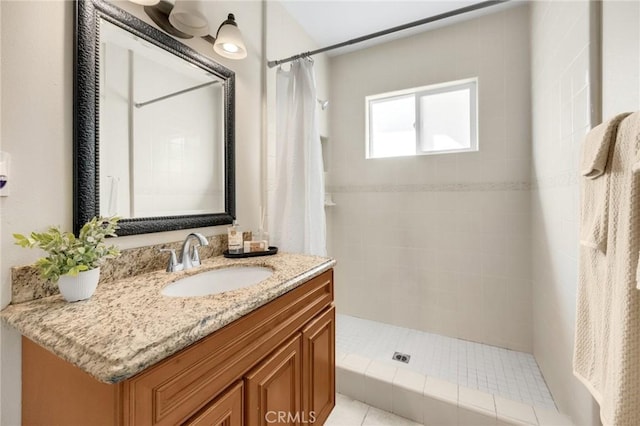 bathroom featuring vanity and a shower stall