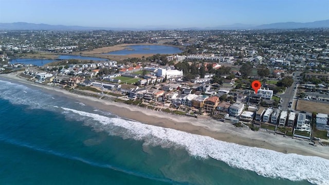 aerial view with a water and mountain view and a view of the beach