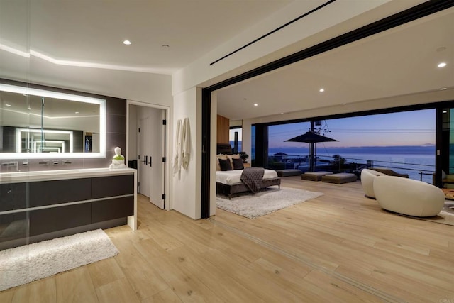 bathroom with a water view, wood-type flooring, and vanity