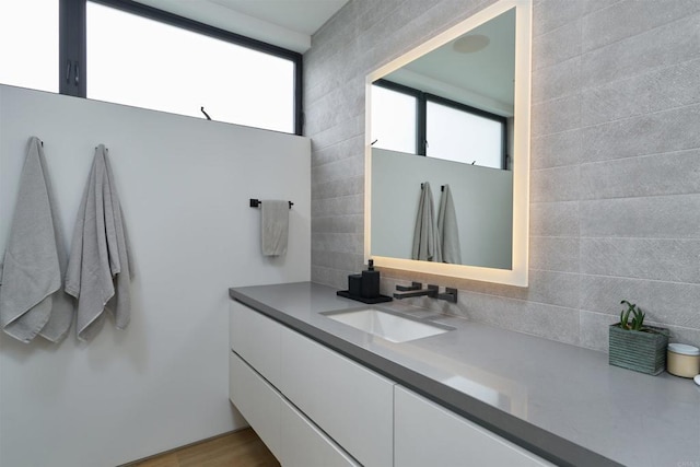 bathroom featuring decorative backsplash and vanity