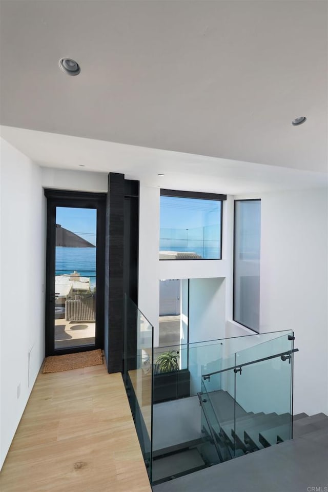 interior space featuring a water view and light wood-type flooring