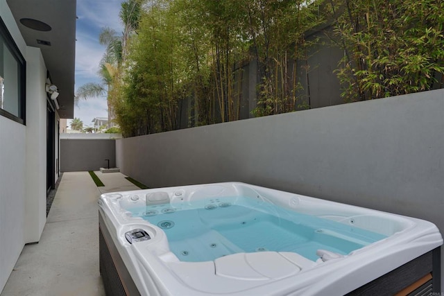 exterior space with a hot tub