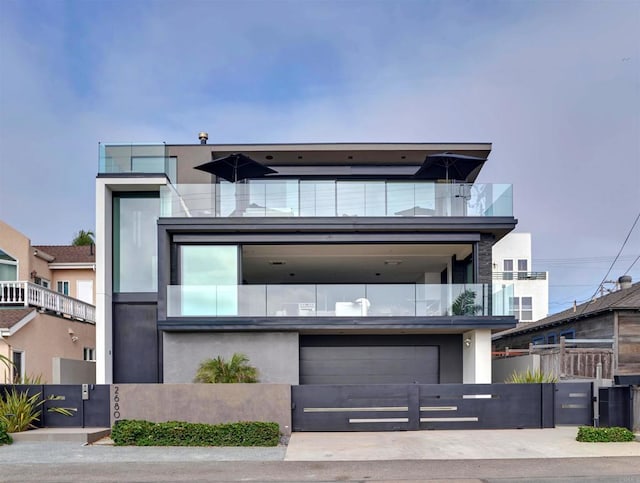 view of front of property featuring a garage and a balcony