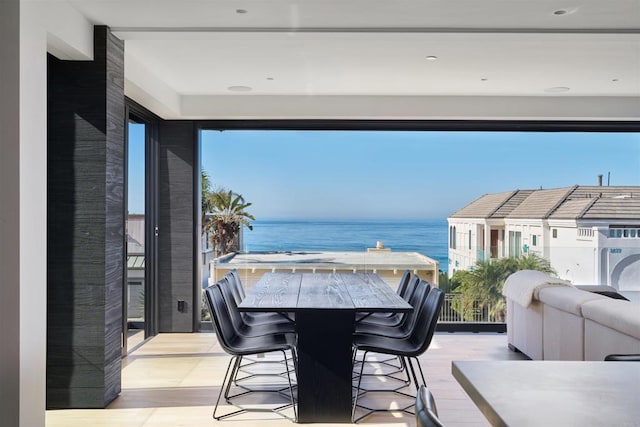 balcony featuring a water view and a bar