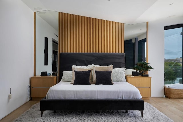 bedroom featuring light hardwood / wood-style flooring and vaulted ceiling