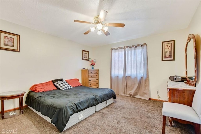 carpeted bedroom featuring baseboards and a ceiling fan