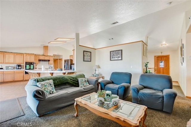 living room featuring lofted ceiling, a textured ceiling, light tile patterned flooring, and visible vents