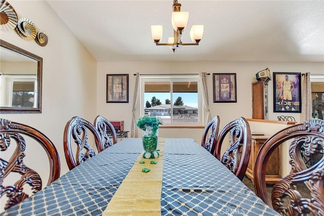 dining area featuring a notable chandelier