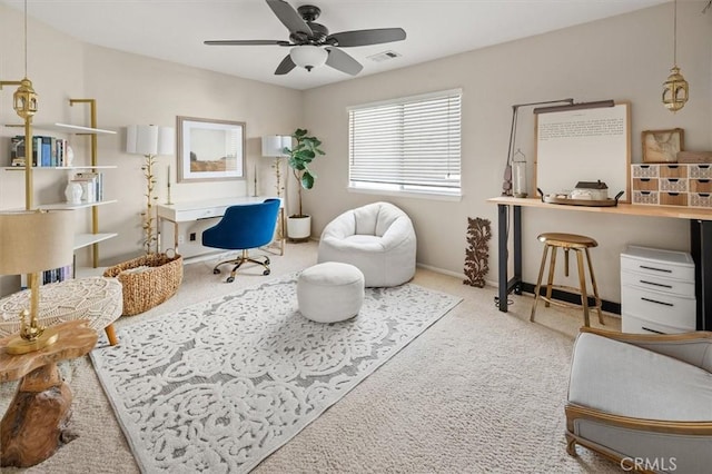 living area featuring baseboards, carpet, visible vents, and a ceiling fan