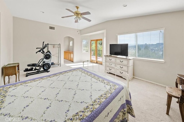 bedroom with arched walkways, visible vents, light carpet, and baseboards