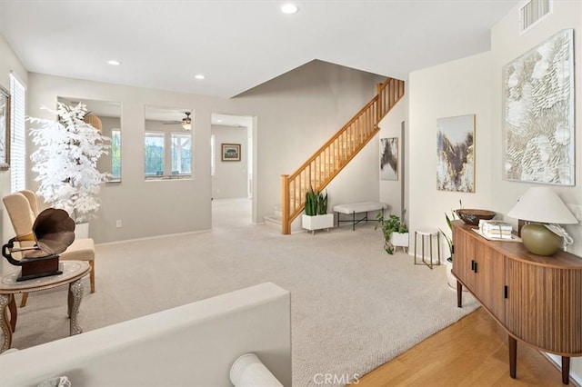 sitting room featuring recessed lighting, wood finished floors, visible vents, stairs, and carpet