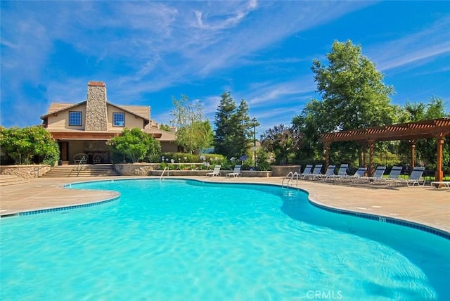 community pool with a patio and a pergola