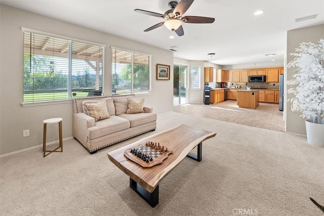 living room with recessed lighting, light carpet, visible vents, baseboards, and a ceiling fan