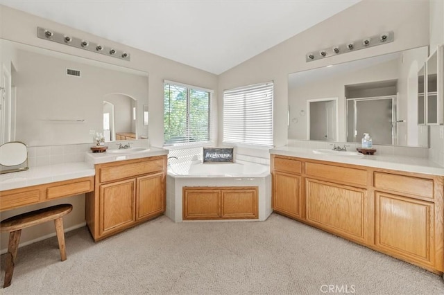 bathroom featuring carpet, a garden tub, vaulted ceiling, and visible vents