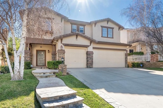 view of front facade with driveway, stone siding, an attached garage, fence, and stucco siding