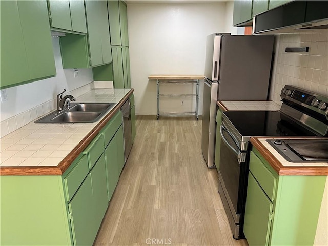 2929 Waverly Dr Unit 213, Los Angeles, CA 90039 - kitchen with a sink, range with electric cooktop, light wood-style flooring, green cabinetry, and decorative backsplash