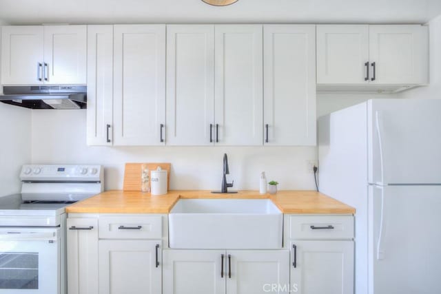 kitchen with sink, white appliances, and white cabinetry