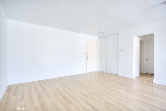 spare room with light hardwood / wood-style floors