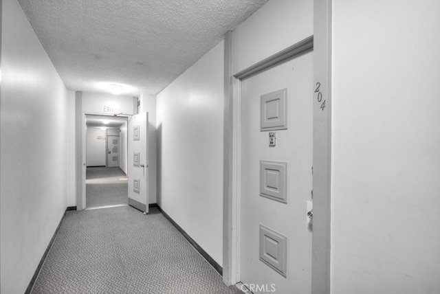 hallway with a textured ceiling