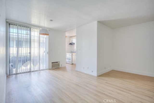 empty room with light hardwood / wood-style flooring