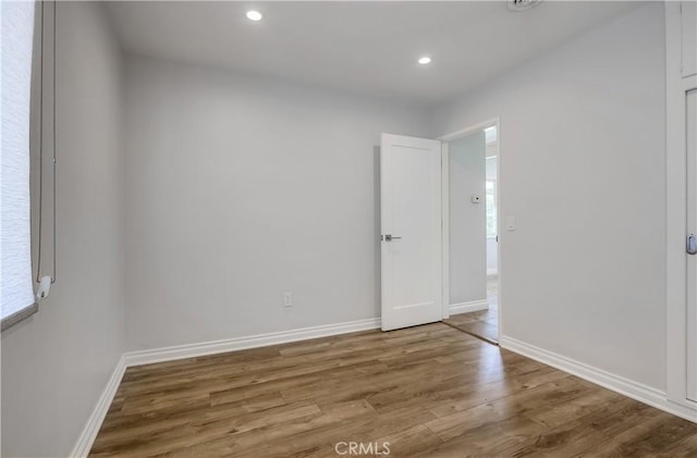 unfurnished bedroom with hardwood / wood-style flooring