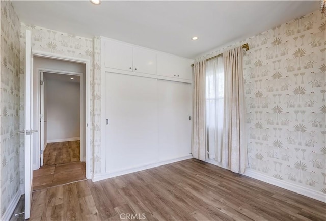 unfurnished room featuring hardwood / wood-style flooring