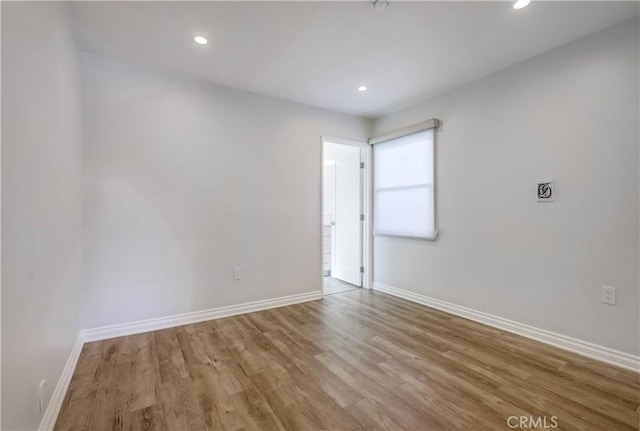 unfurnished room with light hardwood / wood-style floors