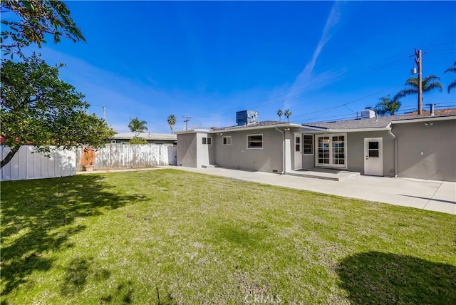 back of property with a patio and a yard