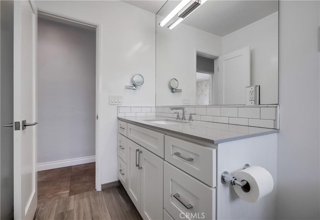 bathroom with decorative backsplash and vanity