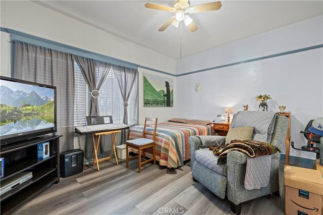 bedroom featuring a ceiling fan and wood finished floors