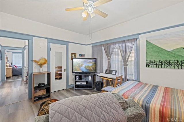 bedroom with ceiling fan and wood finished floors