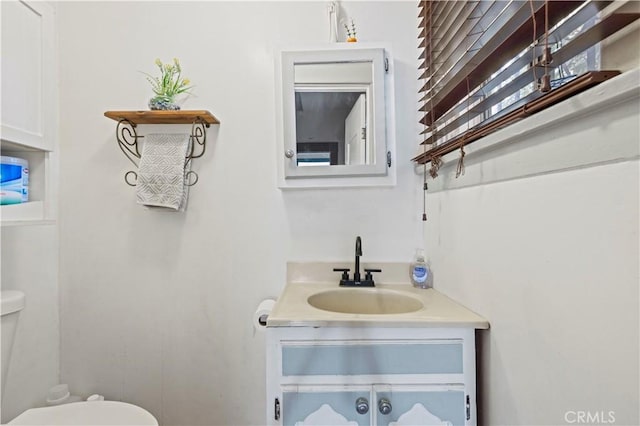 half bath with vanity and toilet