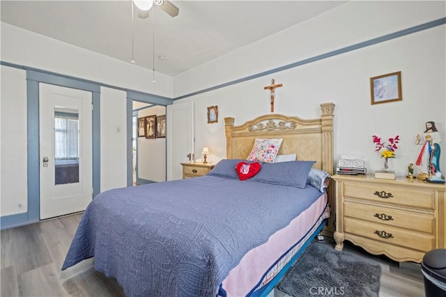 bedroom with light wood-style floors and a ceiling fan