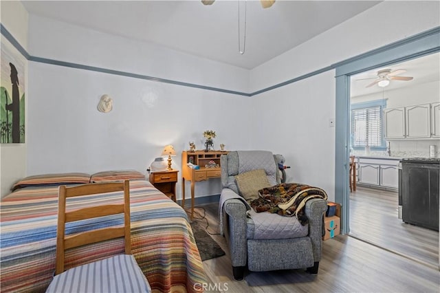 bedroom with light wood-type flooring and a ceiling fan