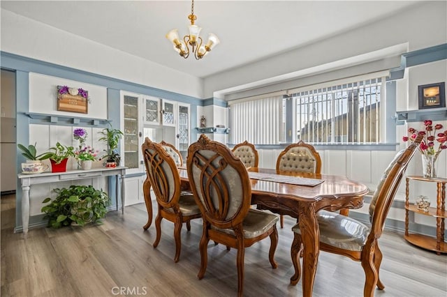 dining space with a chandelier and light wood-style floors