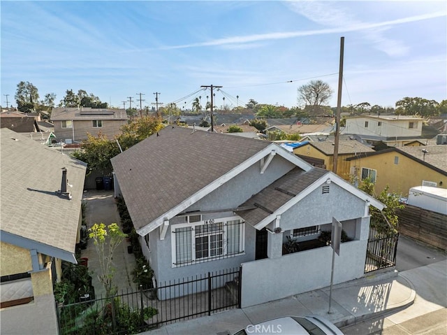 view of front of property featuring a fenced front yard, a residential view, and stucco siding