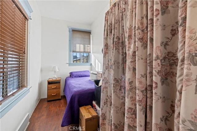bedroom featuring dark wood finished floors