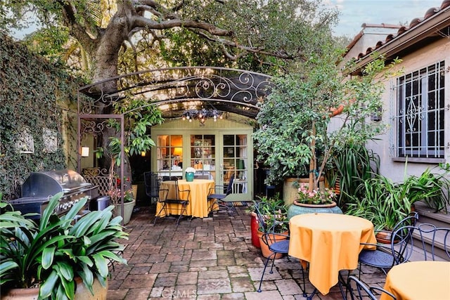 view of patio with french doors and a grill