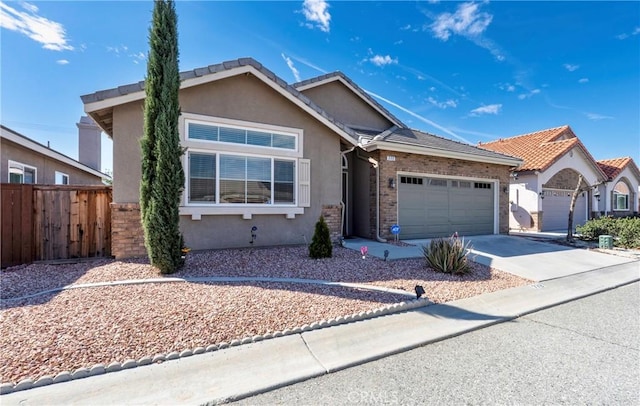 ranch-style house featuring a garage, brick siding, fence, concrete driveway, and stucco siding