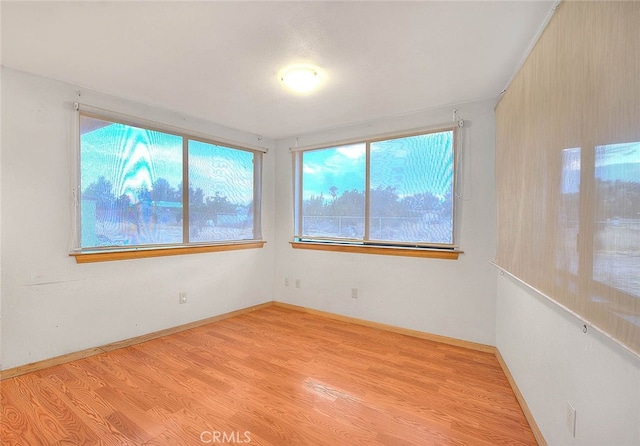 unfurnished room with light hardwood / wood-style flooring