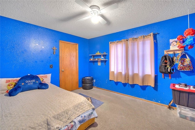 bedroom featuring ceiling fan, carpet floors, and a textured ceiling