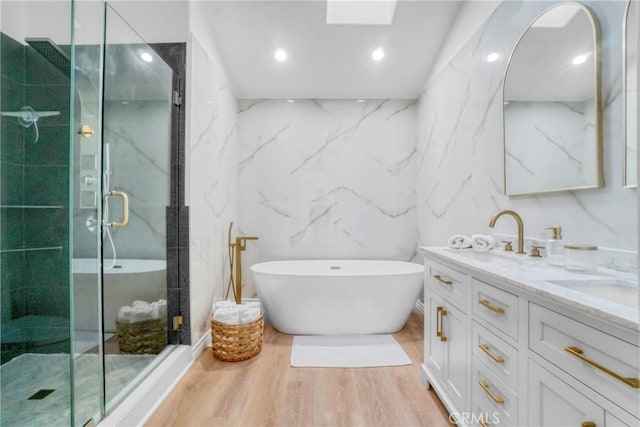 bathroom featuring separate shower and tub, vanity, and hardwood / wood-style floors