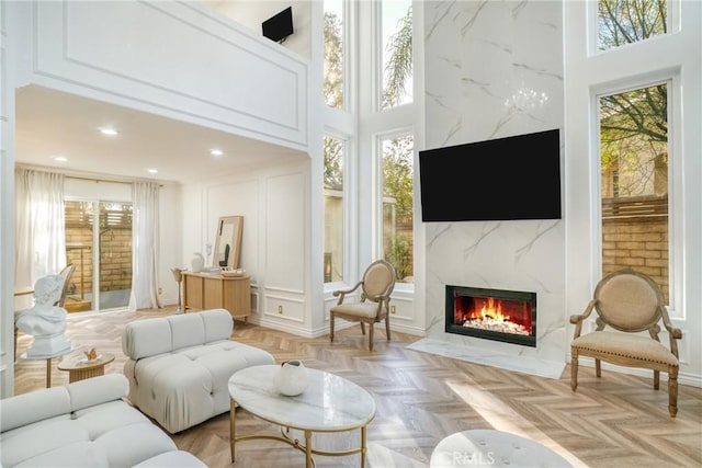 sunroom featuring a high end fireplace