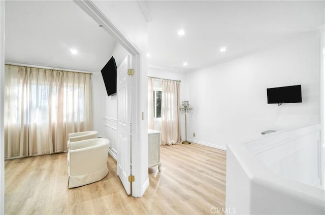 hallway with light hardwood / wood-style flooring