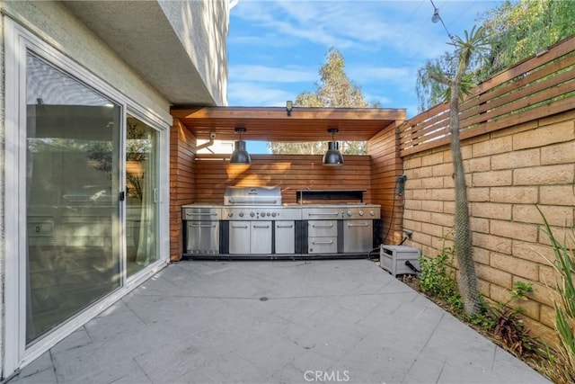 view of patio with a grill and exterior kitchen